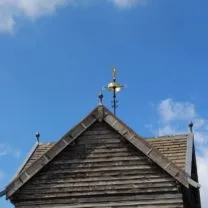 Image showing the tip of the Tower with the repaired timber panelling and the restored weathervane