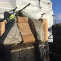 Image showing new carved stone fitted beside existing coping stone