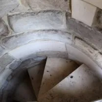 Image showing the new stonework installed to the walls and steps of the spiral staircase leading up to the Nave Roof